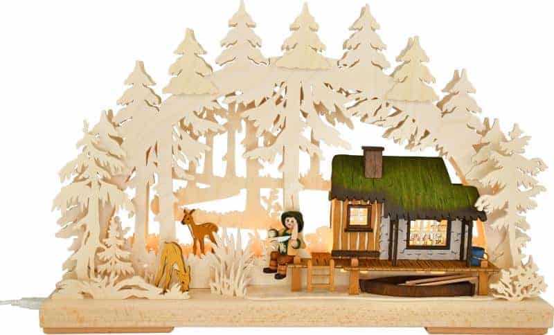 Traditional German Schwibbogen candle arch with illuminated house by the lake